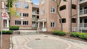 Mississauga (Hurontario) condo for rent - A courtyard surrounded by apartment buildings with a no parking sign.