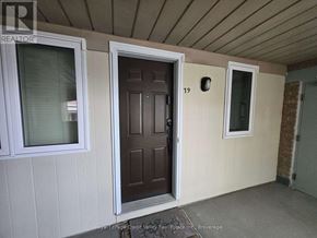 Mississauga (Hurontario) condo for rent - A brown door is in the middle of a white wall.