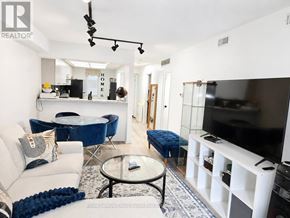 Mississauga (Hurontario) condo for rent - A living room with a white couch and a blue chair.