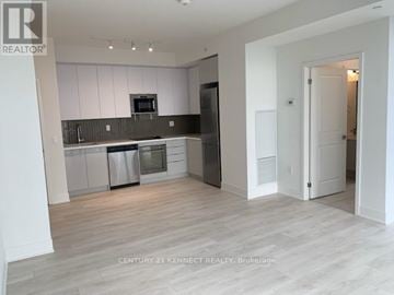 Vaughan (Concord) condo for rent - A kitchen with white cabinets and a grey countertop.