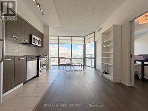 Toronto (Bay Street Corridor) condo for rent - A kitchen with a dining table and chairs in front of a window.