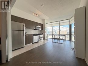 Toronto (Bay Street Corridor) condo for rent - A kitchen with a refrigerator, microwave, and oven.