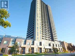 Mississauga (Hurontario) condo for rent - A tall building with a glass facade stands next to a shorter building with a brick facade.