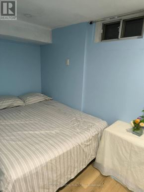 Richmond Hill (Crosby) apartment for rent - A bedroom with a bed and a small table with a vase of flowers on it.