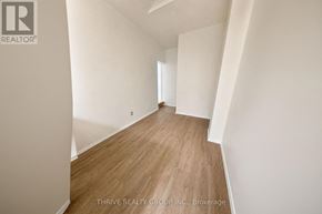 Strathroy-Caradoc (Nw) multi-family for rent - A room with wooden flooring and white walls.