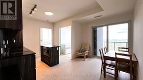 Toronto (Annex) condo for rent - A realtor's office is in the corner of a spacious living room.