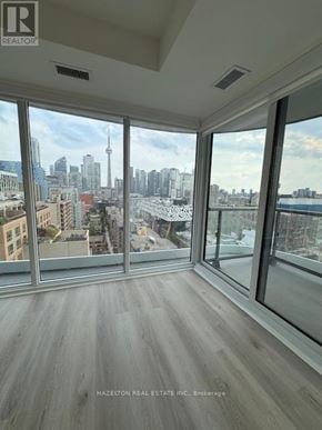 Toronto (Kensington-Chinatown) condo for rent - A room with a view of the city skyline.