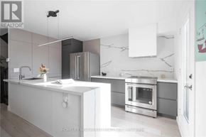 Markham (Cornell) townhouse for rent - A modern kitchen with a white countertop and stainless steel appliances.
