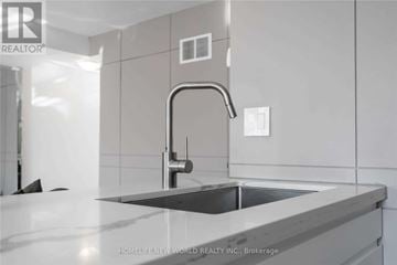 Markham (Cornell) townhouse for rent - A modern kitchen with a sink and a faucet.