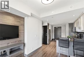 Waterloo condo for rent - A modern kitchen with a bar stool and a television.