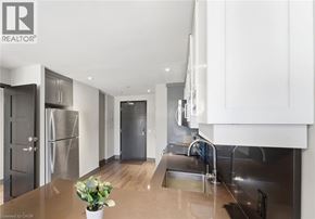 Waterloo condo for rent - A modern kitchen with stainless steel appliances and wooden floors.
