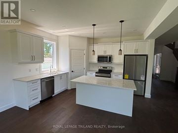 London East (East I) multi-family for rent - A kitchen with white cabinets and a granite countertop.