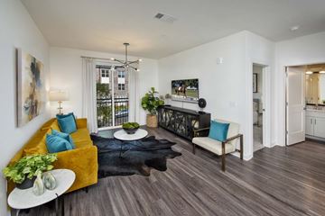Cumming apartment for rent - A living room with a yellow couch and a black rug.