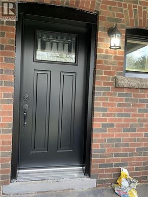 Hamilton apartment for rent - A black door with a glass window above it.