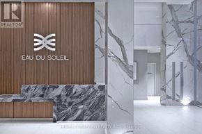 Toronto (Mimico) condo for rent - A modern lobby with a marble floor and a wooden wall with a logo on it.