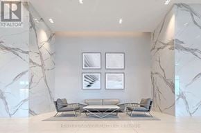 Toronto (Mimico) condo for rent - A living room with a grey sofa set and marble walls.