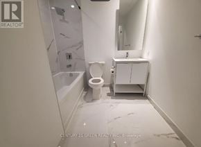 Toronto (Church-Yonge Corridor) condo for rent - A white bathroom with a toilet, sink, and marble flooring.