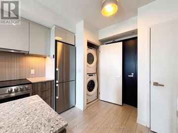 Toronto (Clanton Park) condo for rent - A kitchen with a stove top oven and a refrigerator.