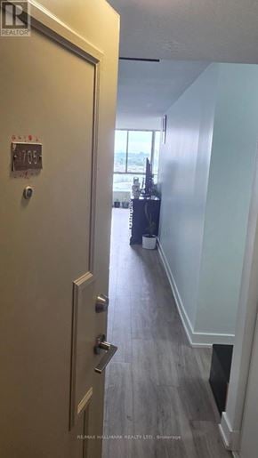 Toronto (Brookhaven-Amesbury) condo for rent - A white door with a silver handle and a small plaque on it.