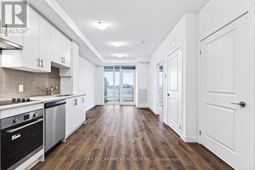 Hamilton (Lakeshore) condo for rent - A kitchen with white cabinets and a stove top oven.