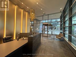 Toronto (Waterfront Communities) condo for rent - A well-lit office lobby with a reception desk and chairs.