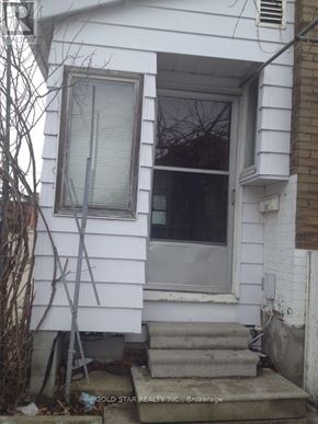 Oshawa (Central) apartment for rent - A white house with a window and a door.