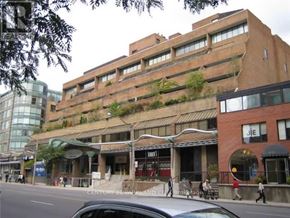 Toronto (Annex) condo for rent - A large building with a green plant on the side.