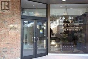 Toronto (Annex) condo for rent - The entrance to a building with a glass door and a brick wall.