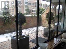 Toronto (Annex) condo for rent - A balcony with a potted plant and a chair.
