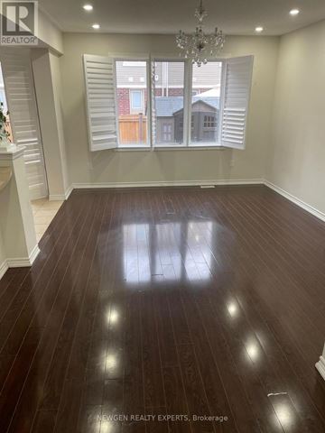 Brampton (Northwest Brampton) apartment for rent - A room with wooden flooring and a chandelier.