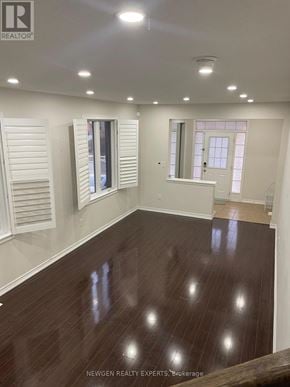 Brampton (Northwest Brampton) apartment for rent - A room with wooden floors and white walls.