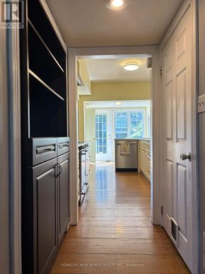 Toronto (High Park-Swansea) apartment for rent - A hallway with a kitchen on one side and a laundry room on the other.