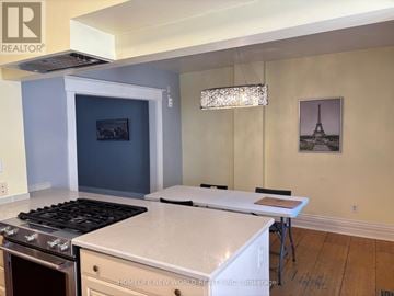 Toronto (High Park-Swansea) apartment for rent - A kitchen with a stove top oven and a counter top.