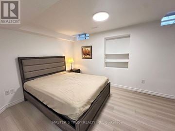 Richmond Hill (Rouge Woods) apartment for rent - A bedroom with a large bed and a picture on the wall.