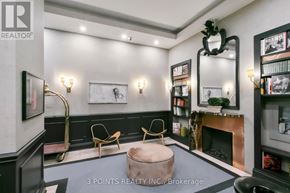 Toronto (Waterfront Communities) condo for rent - A living room with a fireplace and a mirror on the wall.