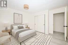 Welland (Lincoln/Crowland) multi-family for rent - A bedroom with a bed, nightstands, and a chair.
