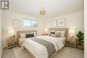 Welland (Lincoln/Crowland) multi-family for rent - A bedroom with a large bed, two nightstands, and a plant.