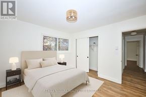 Welland (Lincoln/Crowland) multi-family for rent - A bedroom with a bed, two lamps, and a picture on the wall.