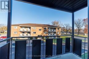 Welland (Lincoln/Crowland) multi-family for rent - A balcony with a view of a building and trees.