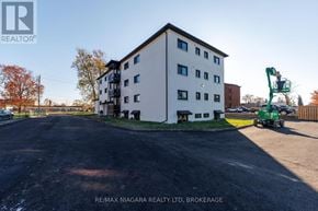 Welland (Lincoln/Crowland) multi-family for rent - A large white building with a green crane in front of it.