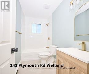 Welland (Lincoln/Crowland) multi-family for rent - A bathroom with a toilet, sink and mirror.