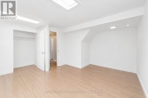 Hamilton (Ainslie Wood) apartment for rent - A spacious room with wooden flooring and white walls.