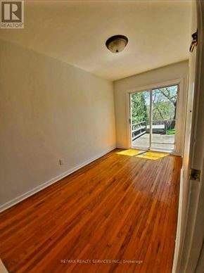 Hamilton (Ainslie Wood) apartment for rent - A room with wooden floors and a door leading outside.