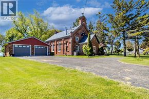 Merlin apartment for rent - A large red brick house with a garage and a driveway in front.