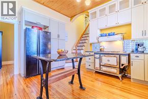 Merlin apartment for rent - A kitchen with a black fridge and a black table.
