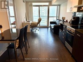 Toronto (Mount Pleasant West) condo for rent - A well-lit, spacious kitchen and living room with dark wood floors and modern appliances.