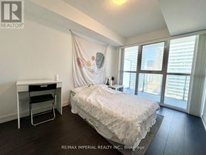 Toronto (Mount Pleasant West) condo for rent - A bedroom with a bed, desk, and chair.