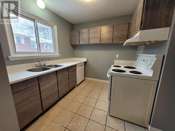 London North (North F) townhouse for rent - A kitchen with a stove, sink, and cabinets.