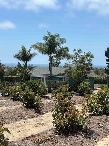 Carpinteria apartment for rent - A house with a green lawn and trees in front.