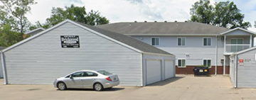 Fargo apartment for rent - A silver car is parked in front of a garage.